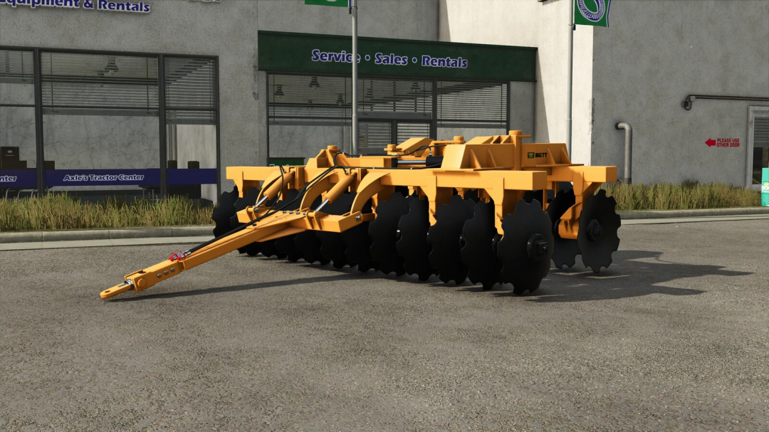 Farming Simulator 25 mod, TT Big TT v1.0.0.0 plow, yellow farming implement parked outside a rental and service shop in the game.