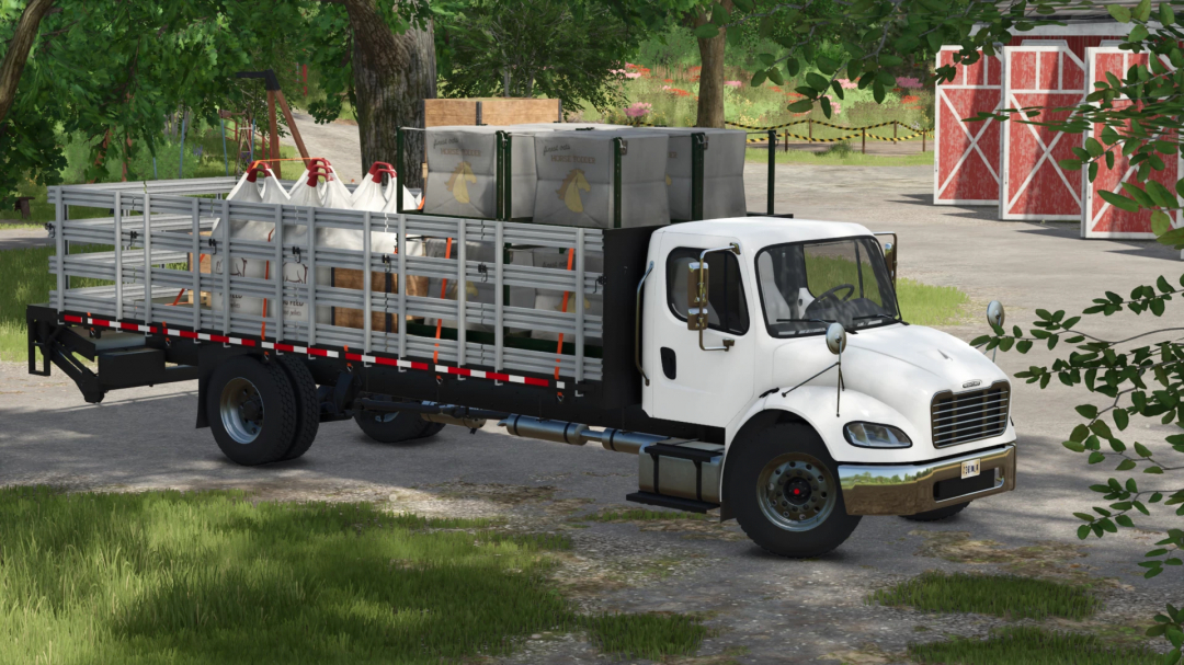 Farming Simulator 25 mod: Freightliner M2 Stakebed v1.2.0.0 truck loaded with bags and pallets, parked in a farm yard with trees and barns.