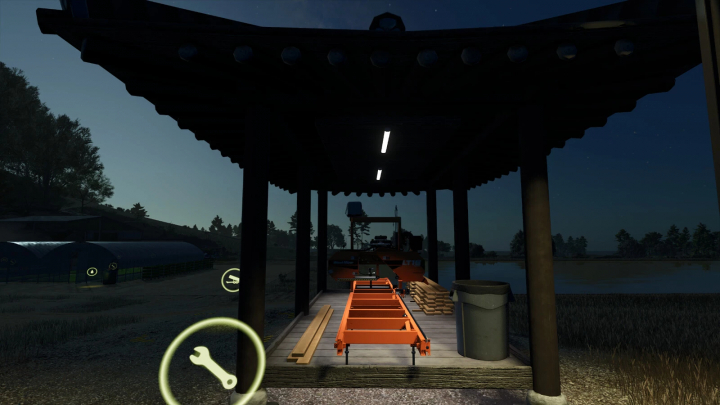 fs25-mods,  Farming Simulator 25 mod: Small Sawmill v1.0.0.0 under a shelter at night, with wood planks and a trash bin nearby.
