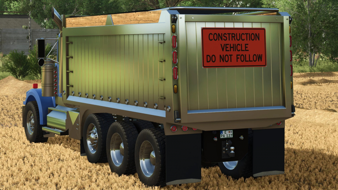 FS25 mod: Construction vehicle Western Star 4964 dump truck with warning sign, in a rural field setting, for Farming Simulator 25.