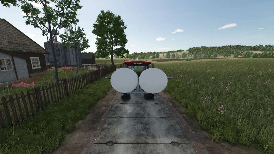 Farming Simulator 25 mod: tractor with a concrete plate 3m for FS25 gameplay, on a rural farm road surrounded by fields and houses.