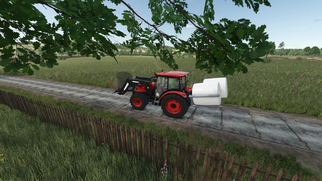 Farming Simulator 25 mod: Red tractor with a white concrete plate attachment on a rural field road.