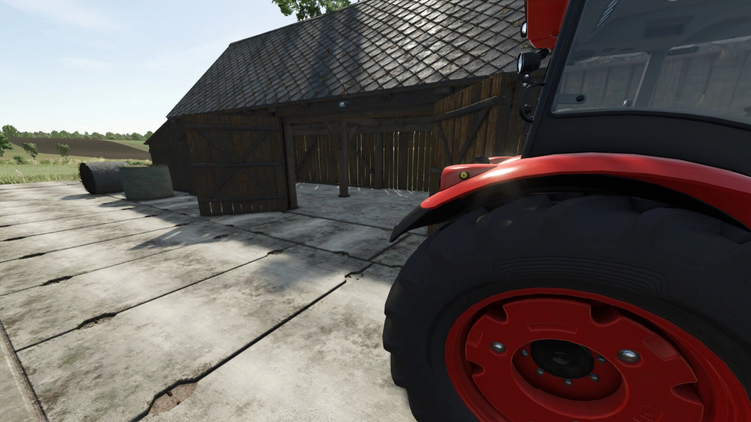 Farming Simulator 25 mod showing a tractor tire near a wooden barn with concrete flooring and hay bales, featuring the Concrete Plate 3m mod.