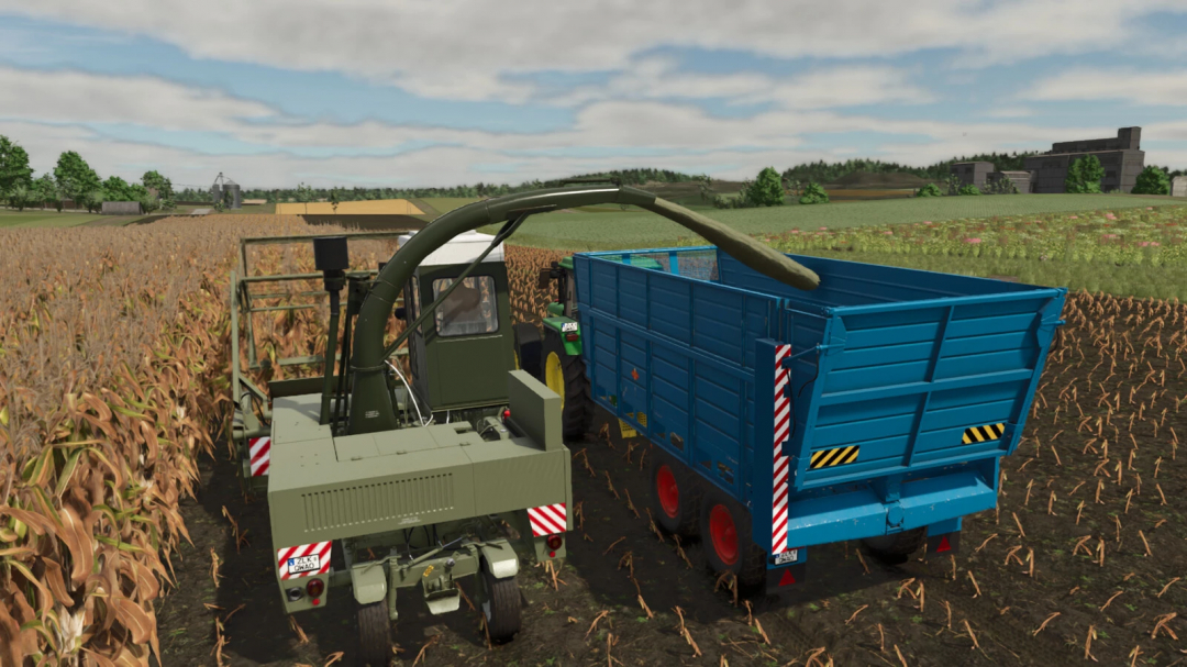 FS25 mod: Progress T 088 Pack harvesting corn with a modern forage harvester and trailer on a farm field.