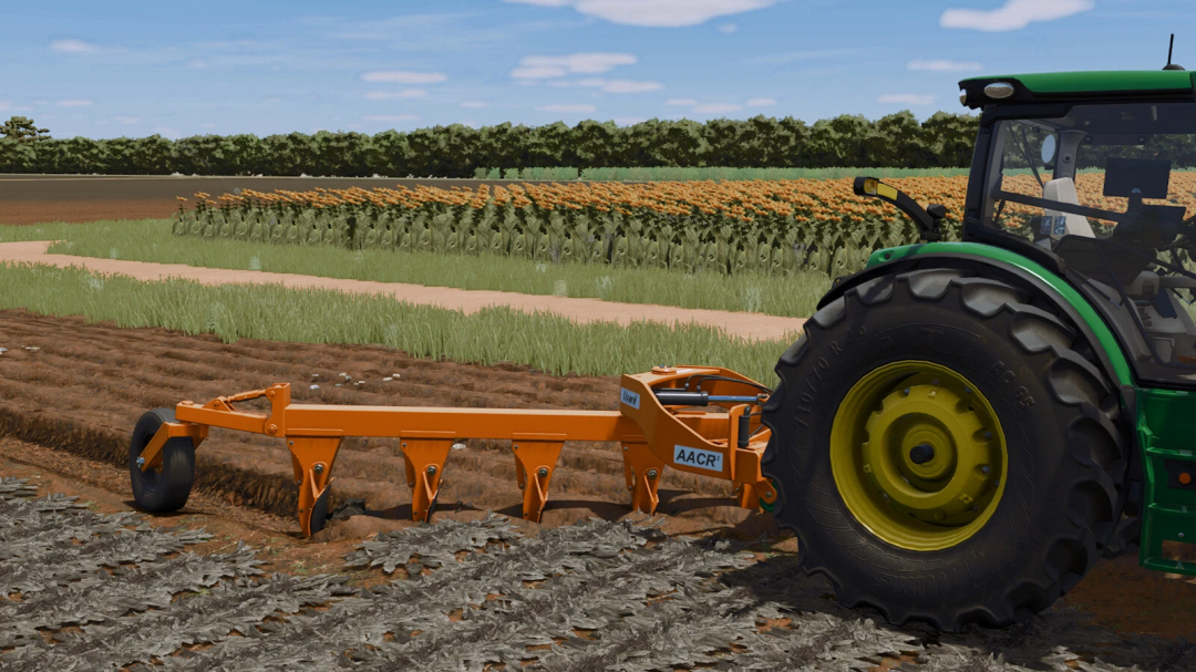 Farming Simulator 25 mod: orange AACR2 tillage implement attached to a green tractor in a field with sunflowers and crops.