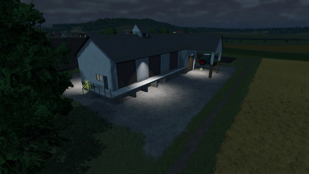 Night view of a farm building in Farming Simulator 25 with pig food production mod installed, illuminated by exterior lights.