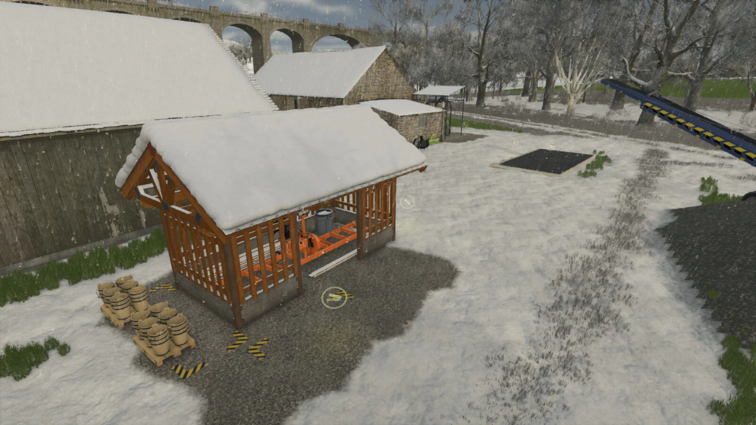 Snow-covered small sawmill structure from Farming Simulator 25 mods, with stacks of sawdust bags nearby, in a snowy farm scene.
