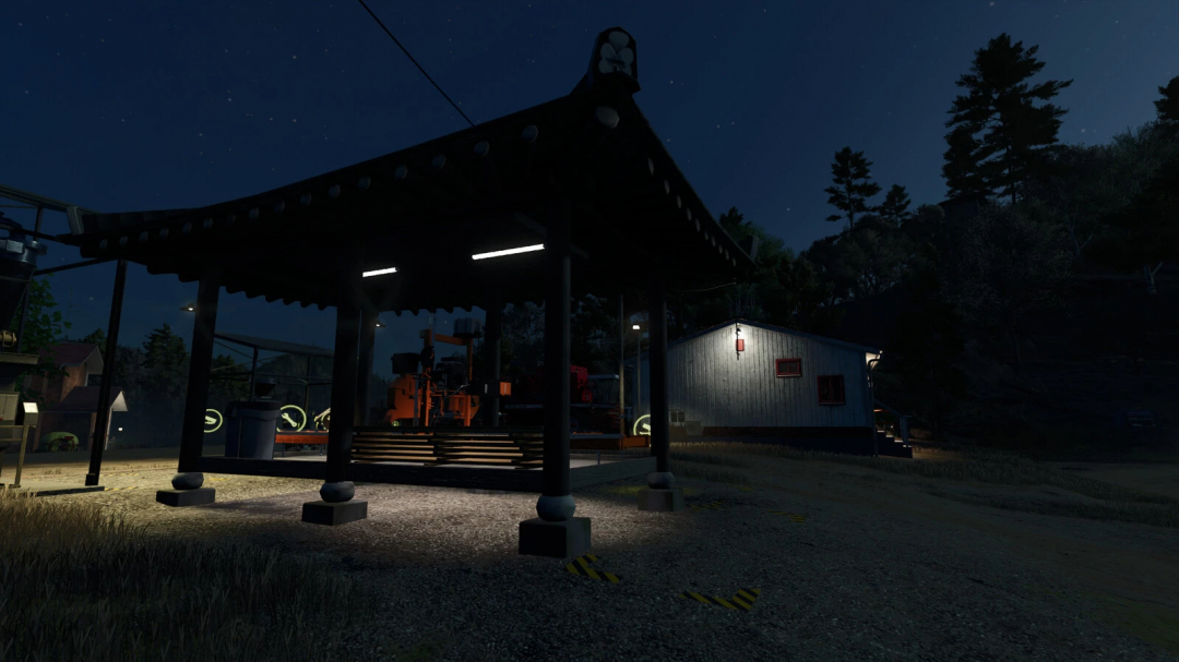 Night view of a small sawmill in Farming Simulator 25, part of FS25 mods, showing the mill under the dark sky with surrounding trees.