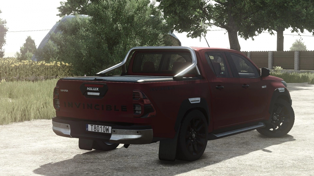 Gaming scene from Farming Simulator 25 showcasing a red Toyota Hilux Invincible 2021 mod with black wheels and a rear roll bar.