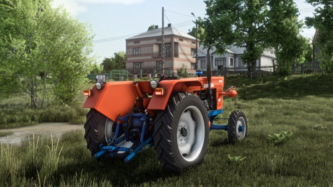 Farming Simulator 25 mod featuring the vintage orange UTB 651 tractor in a rural field setting.