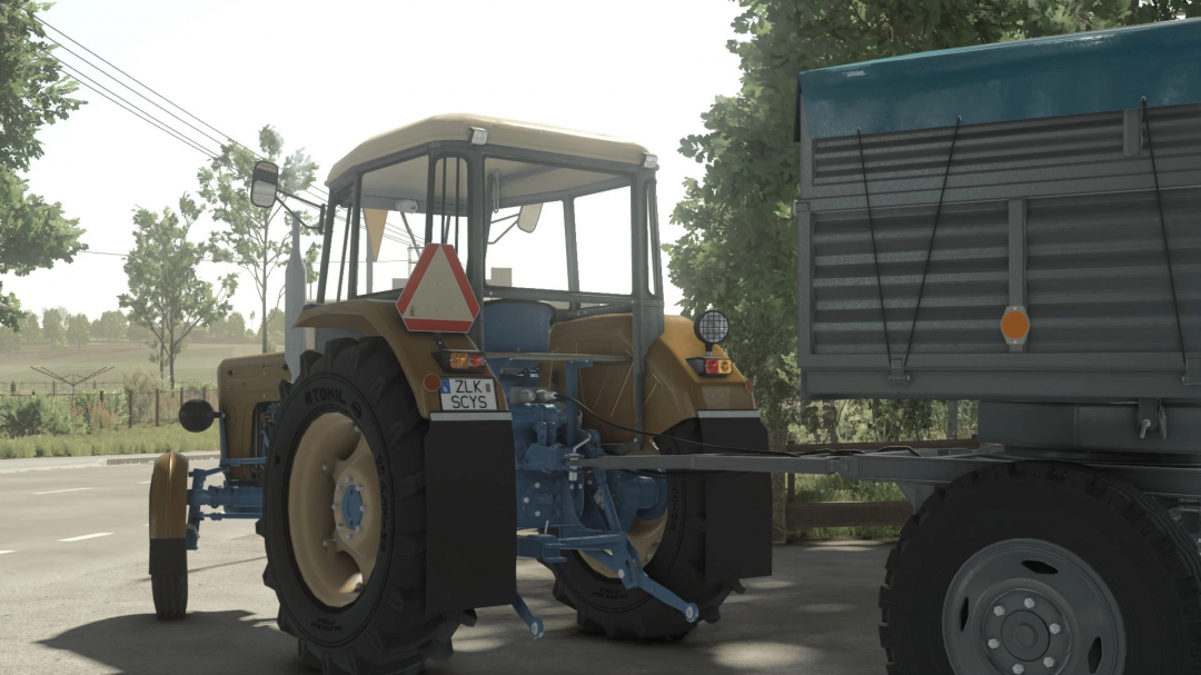 Farming Simulator 25 mod, Ursus C355-C360 Pack v2.0.0.4, tractor with a trailer attached, on a rural road in FS25 game.