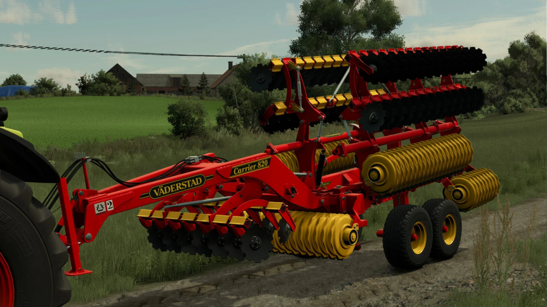 Farming Simulator 25 mod: Väderstad Carrier 820 cultivator with red and yellow design, large discs, working on a farm field.
