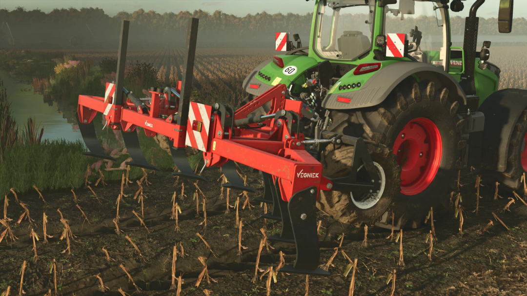 Farming Simulator 25 mod: Vegniek Hunter 600 v1.0.0.0 tractor plowing a field with a red cultivator, near a water body and autumn trees.