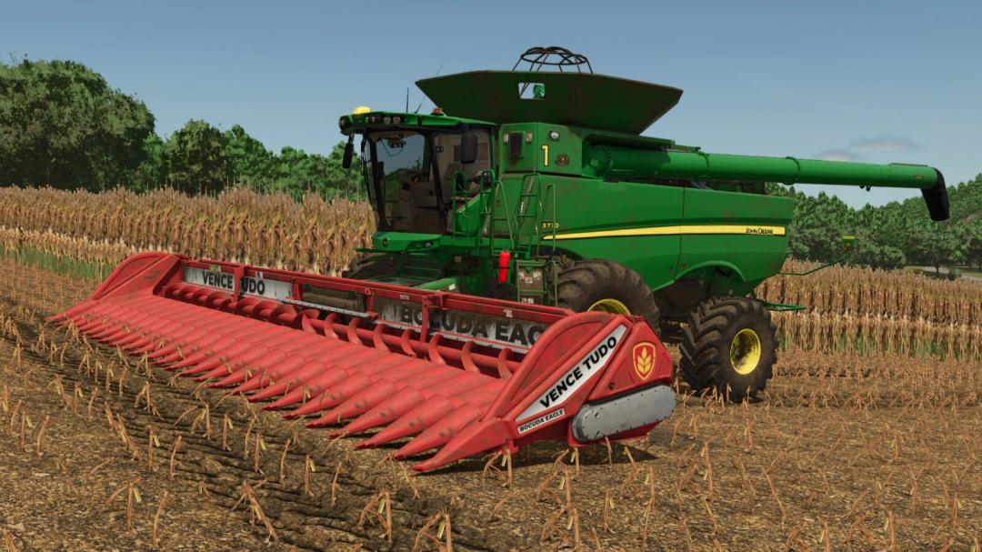 Farming Simulator 25 mod: Green John Deere combine with red Vence Tudo Bocuda Eagle 24 header harvesting crops.