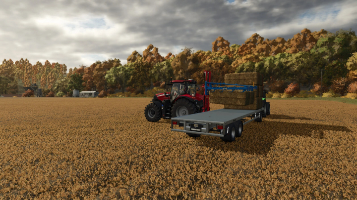 fs25-mods, Farming Simulator 25 mod showing a tractor with a flatbed trailer carrying hay bales, set in a field with autumn trees and cloudy sky.