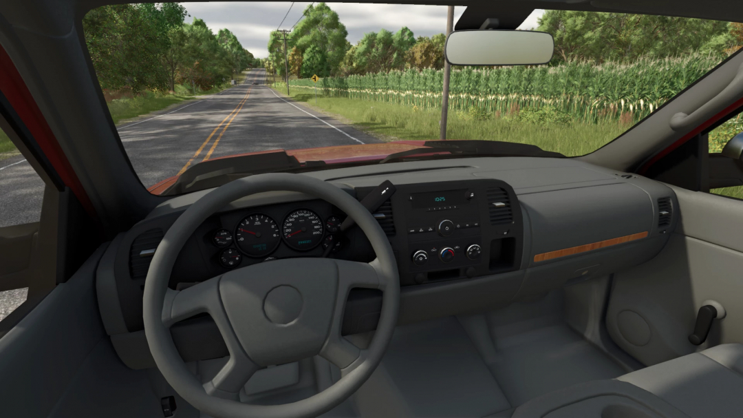 Inside view of a truck in Farming Simulator 25, showing the dashboard, steering wheel, and rural road outside, with a mod of a 2012 Chevy Silverado.