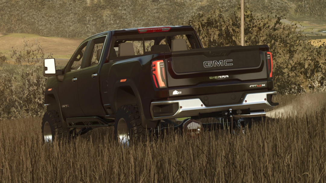 Farming Simulator 25 mod featuring a black GMC Sierra pickup truck with off-road tires in a field.