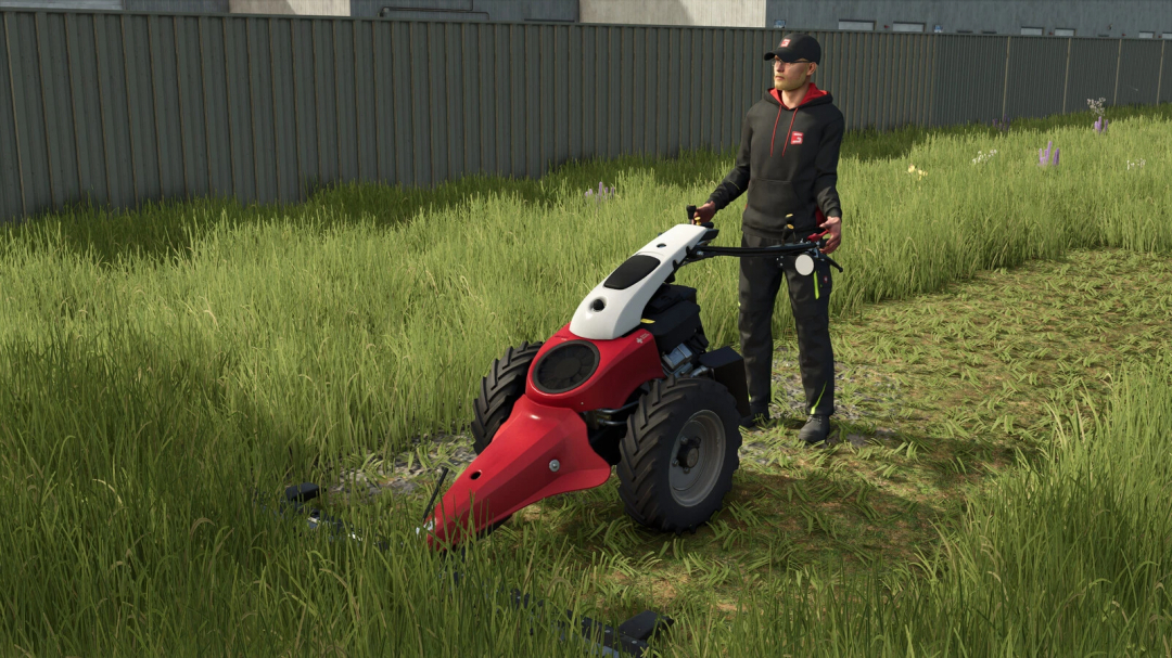 Farmer operating a power scythe mod in Farming Simulator 25, with lush green grass and a metal fence in the background.