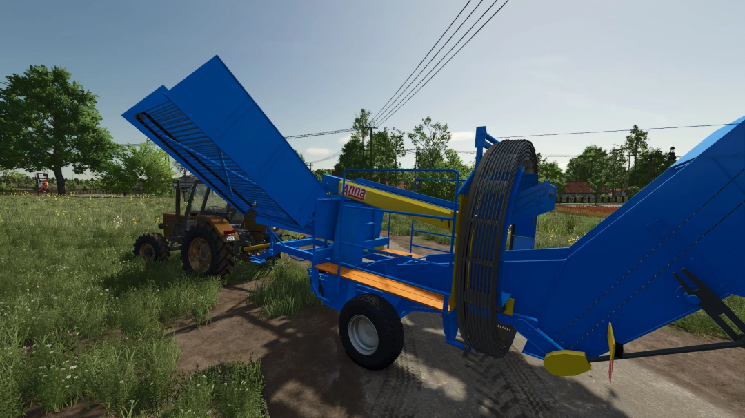 Farming Simulator 25 mod: blue Agromet Z644 Anna harvest trailer with hydraulic lifting, sitting on a farm field.