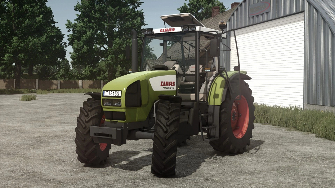 Farming Simulator 25 mod: Claas Ares 600 tractor with green body and red wheels, parked near a shed, for FS25 mods.