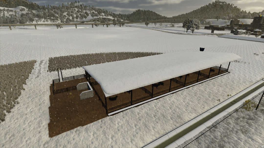 Snow-covered cattle shelter in a farming field, part of FS25 mods for Farming Simulator 25.