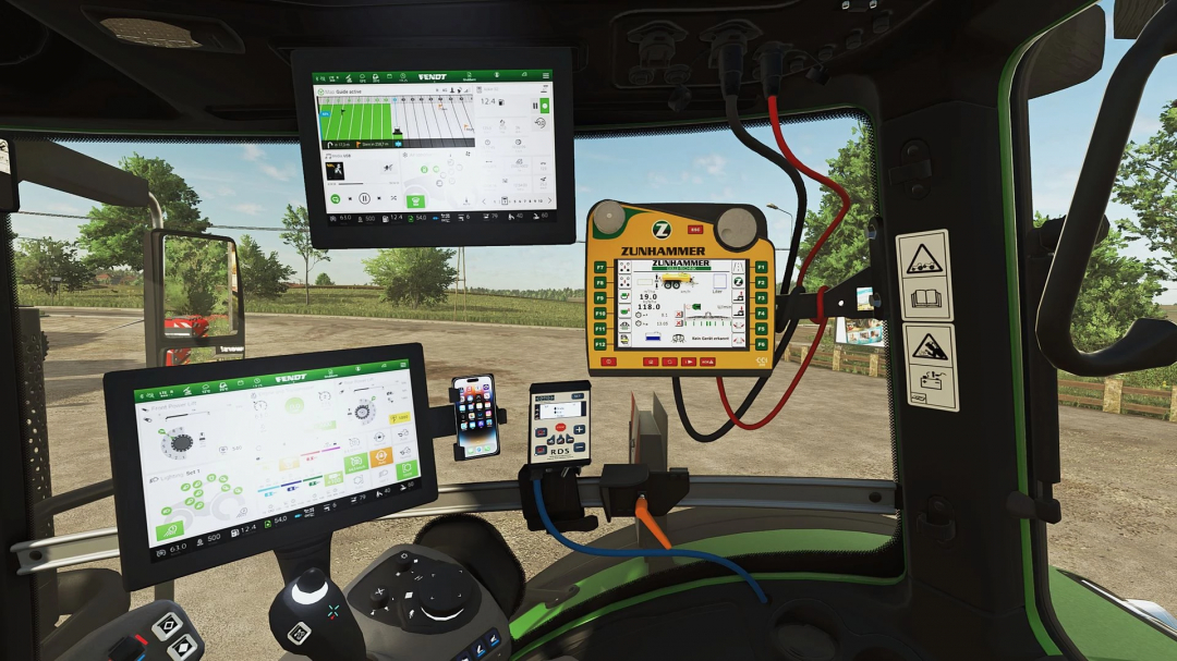 Inside the cab of a Farming Simulator 25 mod tractor with multiple screens, including a Fendt control unit and GPS, showcasing FS25 mods.