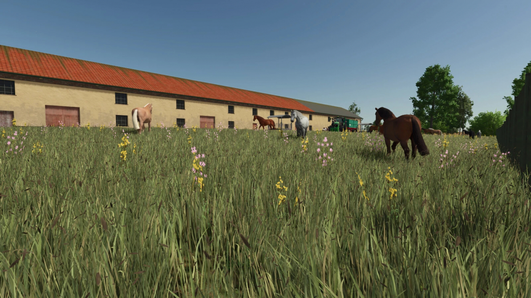 Farming Simulator 25 mods: Horse barn with multiple horses grazing in a grassy field near a large barn building.