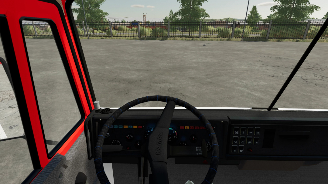 Interior view of a KamAZ truck dashboard in Farming Simulator 22, featuring gauges, controls, and a view of an outdoor lot.