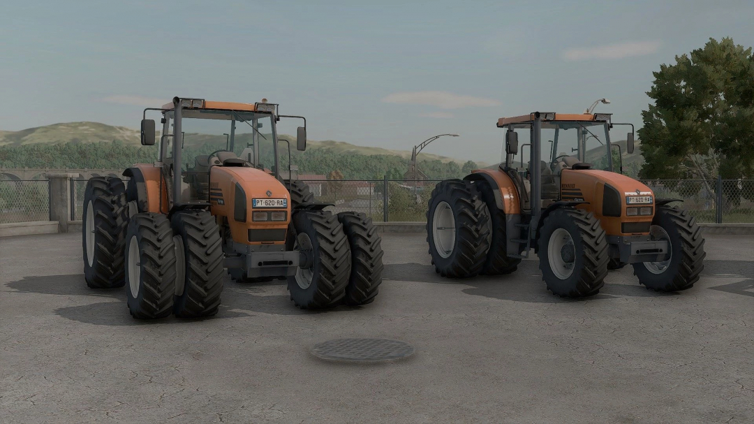 Two Renault 600 Ares tractors from FS25 mods in Farming Simulator 25, parked outdoors on a concrete surface with scenery in the background.