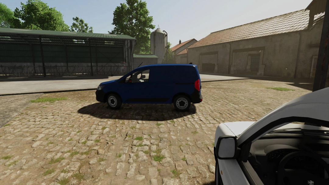 Farming Simulator 25 mod showcasing a blue Renault Kangoo L1H1 2024 vehicle on a farmyard with rustic buildings and cobblestone ground.