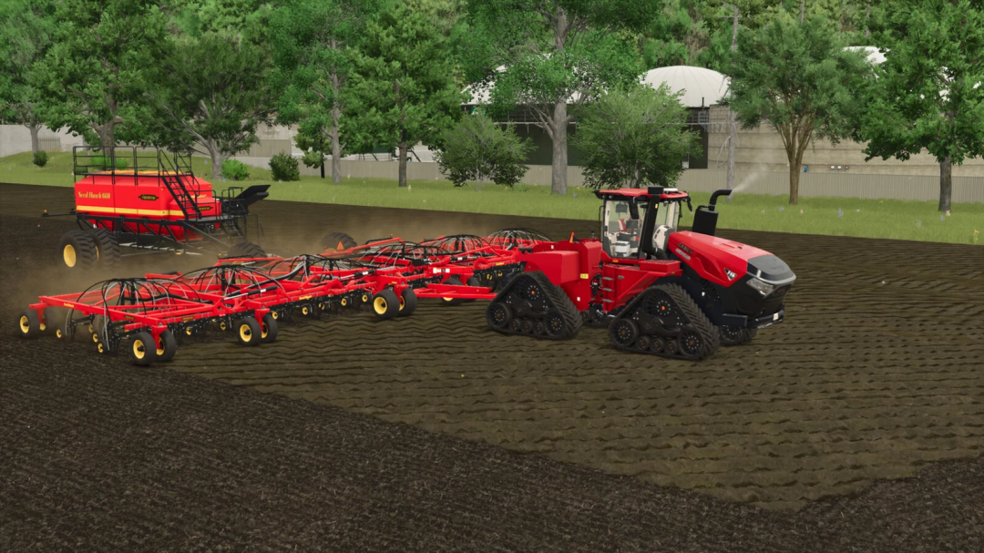 Farming Simulator 25 mod: Red tracked tractor with Seed Hawk pack for planting on fields, with additional seeder in the background.