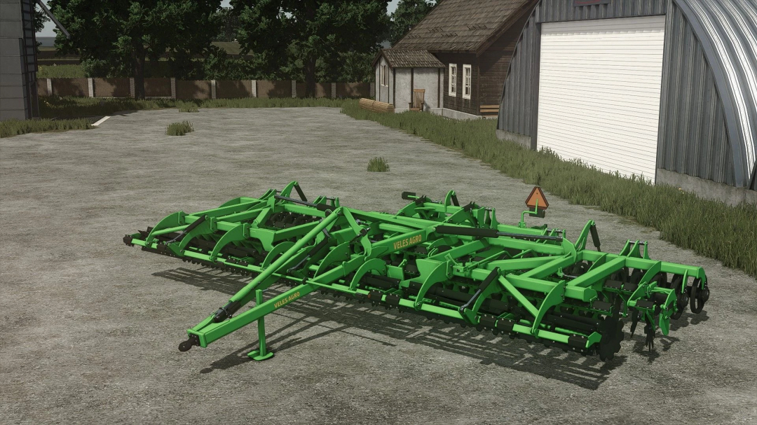 Farming Simulator 25 mod: Veles Agro Disc 8M for soil cultivation, shown in an outdoor farmyard setting.