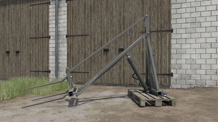 fs25-mods, Back Lifter for tractors v1.0.0.0 from FS25 mods, placed outdoors near a brick wall and wooden shed, displayed on a wooden pallet.