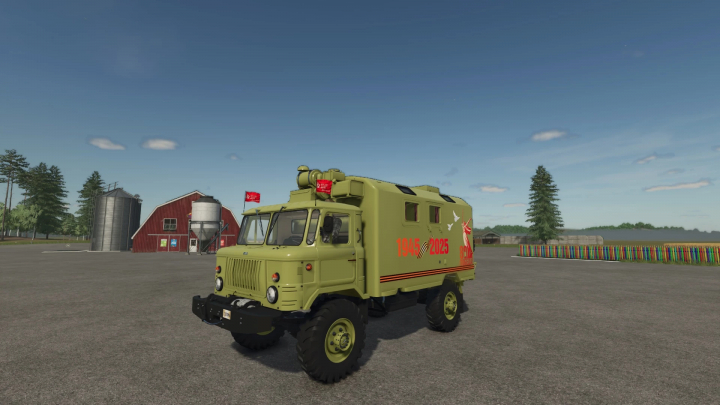 fs25-mods, Farming Simulator 25 mod: GAZ-66 Pobeda military truck with anniversary markings, version 1.0.0.0, on a farmyard with barns and trees in the background.
