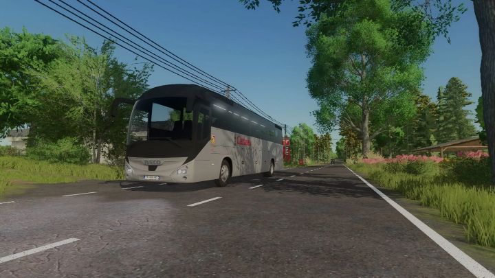 fs25-mods,  Farming Simulator 25 mod featuring an Iveco Magelys Pro 2013 coach bus by Catteau Voyages on a rural road with trees and greenery.