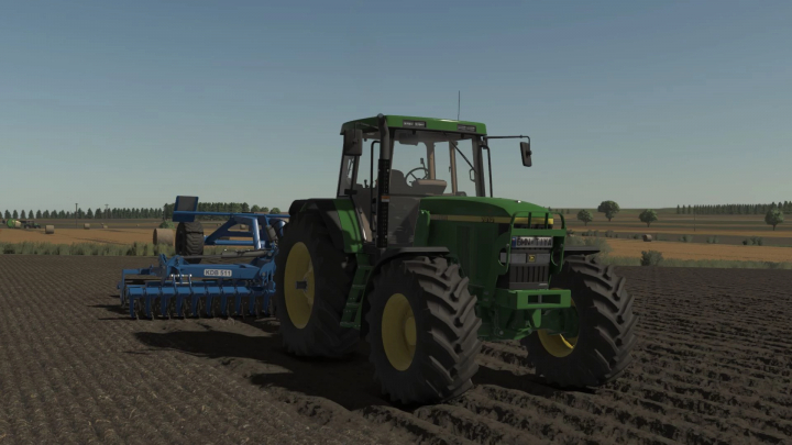 fs25-mods,  Farming Simulator 25 mods: Green John Deere 7xx0 Series tractor with blue cultivator attached in a plowed field.