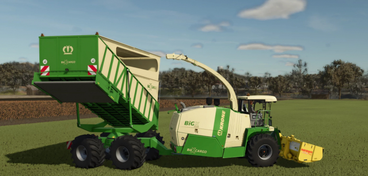 fs25-mods, Farming Simulator 25 mod image of a green and cream Krone BigX 1100 Cargo with a loading container, on a grassy field.