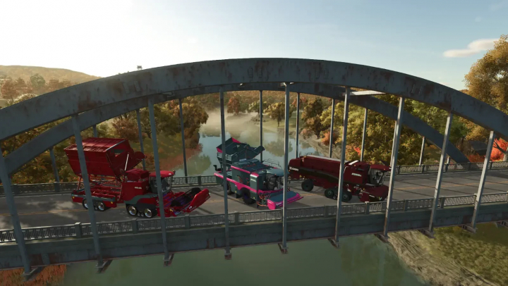 fs25-mods,  Farming Simulator 25 mods: Oxbo Pack v1.1.0.0 on a bridge with farming machinery, surrounded by autumn trees and a river.