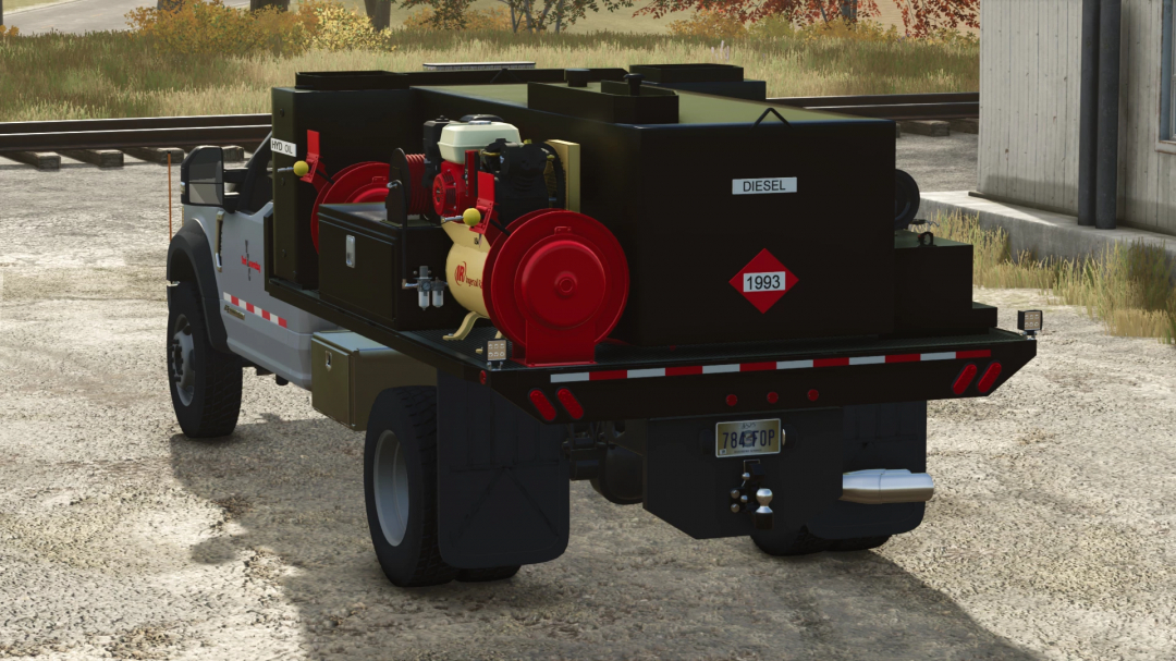 Farming Simulator 25 mod: Black fuel and lube truck with red pumps for diesel fuel, oil, and hazardous materials, used in farming operations.