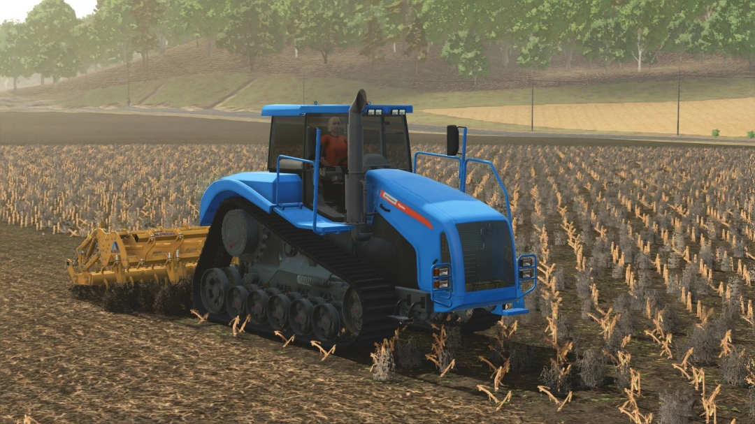 Farming Simulator 25 mod: Blue Agromash-Ruslan tracked tractor with a tiller working on a field.