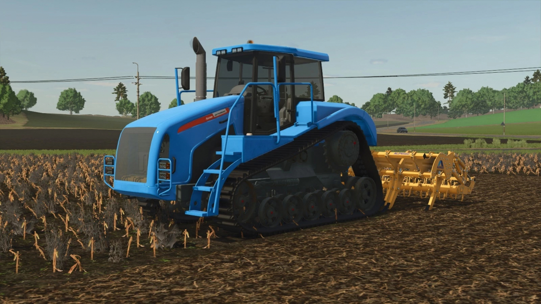 Farming Simulator 25 mod: blue Agromash-Ruslan tractor with tracks working on a farm field, with a yellow cultivator attached.