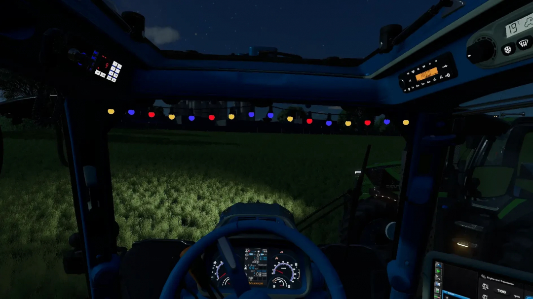 Night view from inside the tractor cab in Farming Simulator 25, featuring dashboard lights and a string of colorful holiday lights.