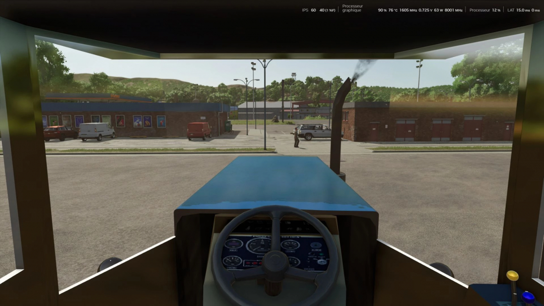 Inside view of a blue tractor from Farming Simulator 25, showing the dashboard and a view of a parking lot with vehicles and buildings outside.