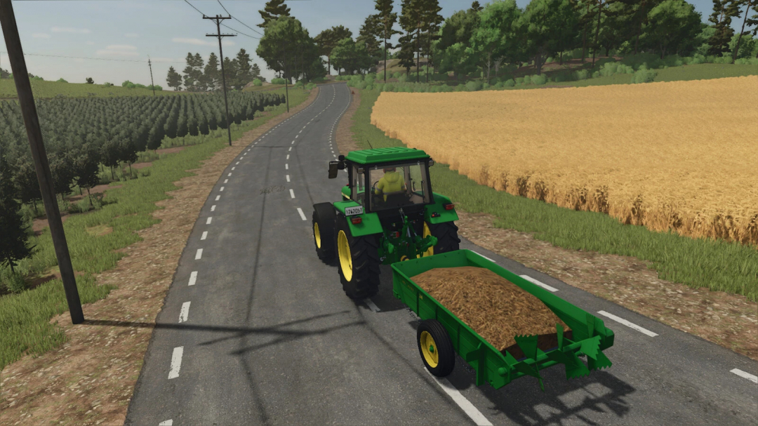 Farming Simulator 25 mod featuring a green John Deere tractor with a trailer, driving along a rural road next to farmland.