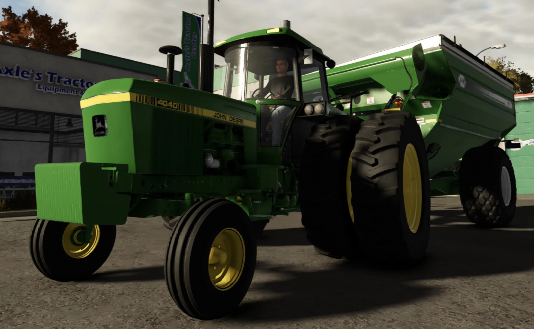 John Deere 40 series tractor mod in Farming Simulator 25, with a green body and large black tires, parked outside a tractor equipment store.