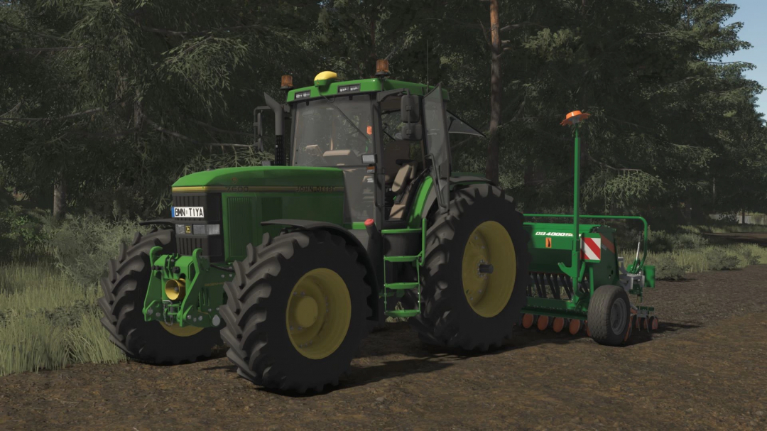 Farming Simulator 25 mods: John Deere 7xx0 Series v1.0.0.0 tractor in a forestry environment with planting equipment attached.