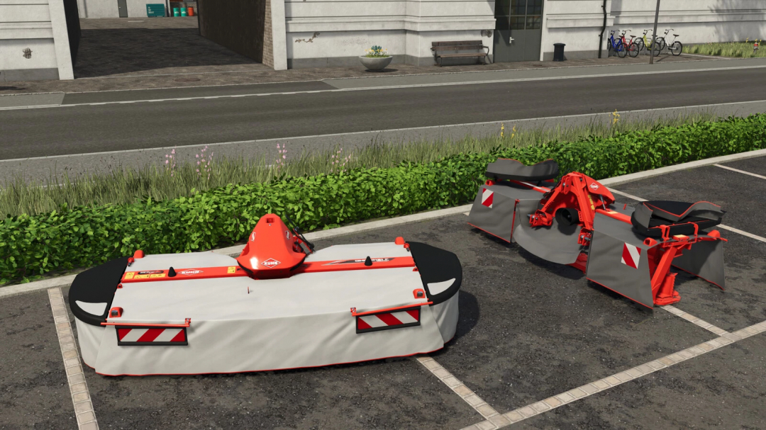 Kuhn GMD COMPACT F Pack v1.0.0.0 mod from Farming Simulator 25, showing two compact farm equipment attachments on a parking lot.