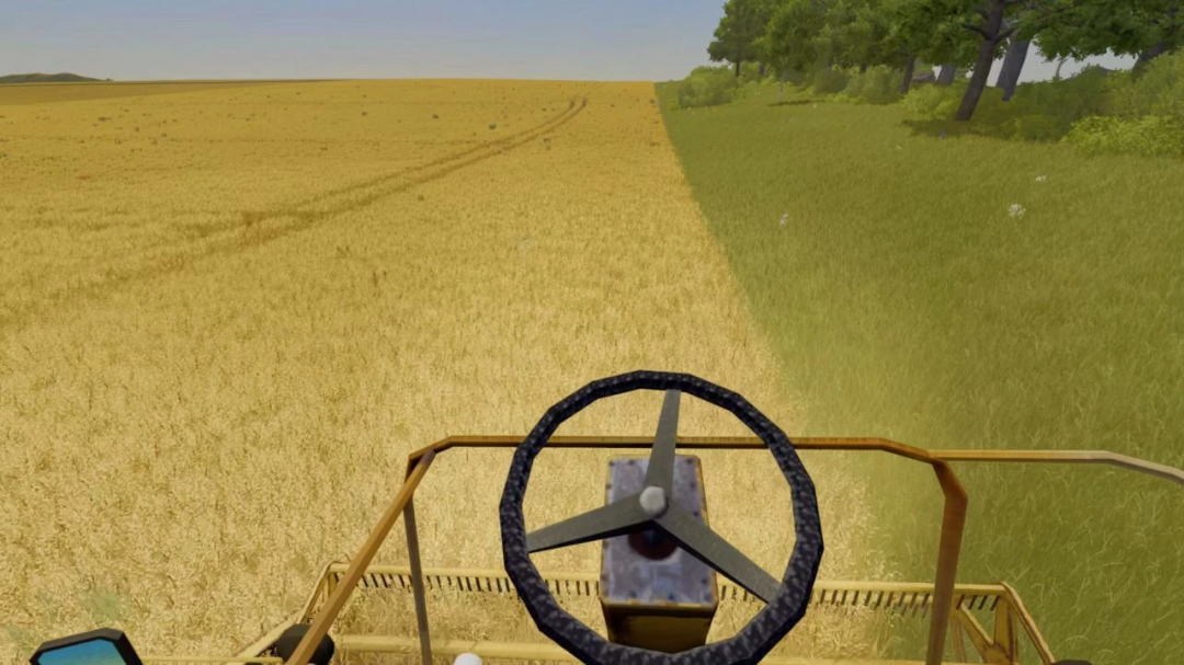 Farming Simulator 25 mod: view from the legendary Lizard 7210 v1.0.0.0 tractor cabin, facing a wheat field with trees on the side.