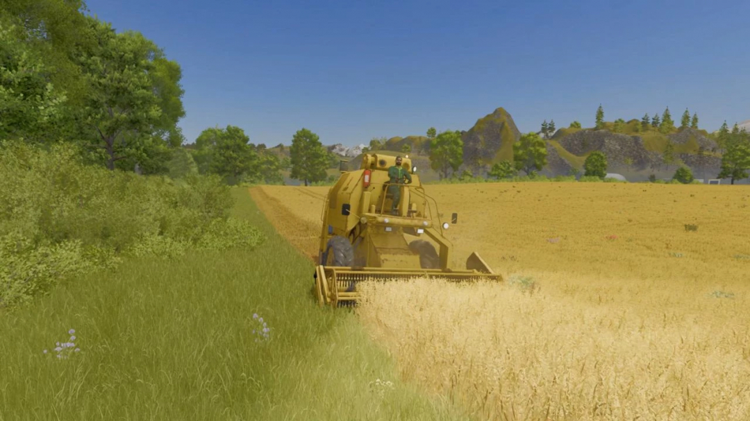 Farming Simulator 25 mod: A yellow combine harvester working in a wheat field under a clear blue sky.