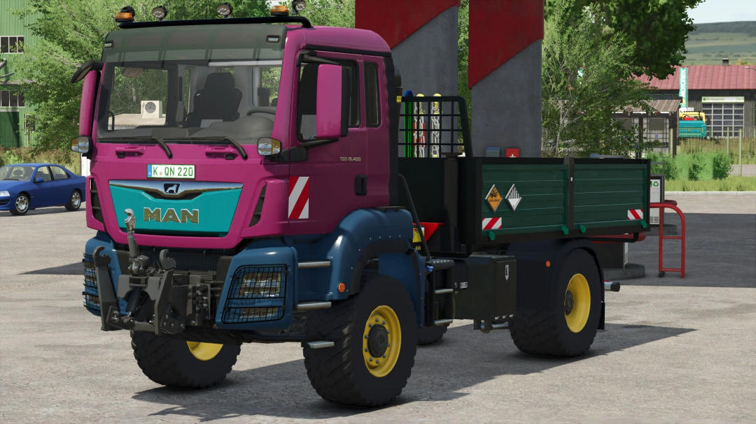 Farming Simulator 25 mod: MAN TGS 18 Series truck with pink cab, green cargo bed, and yellow wheels, parked outdoors.